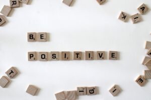 Scrabble tiles spelling out 'Be Positive'