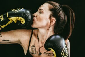 Woman kissing her boxing glove